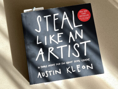 Book "Steal Like an Artist" by Austin Kleon on a table in sunlight