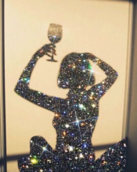 Glittery, shiny silhouette of a women holding a wine glass over her head