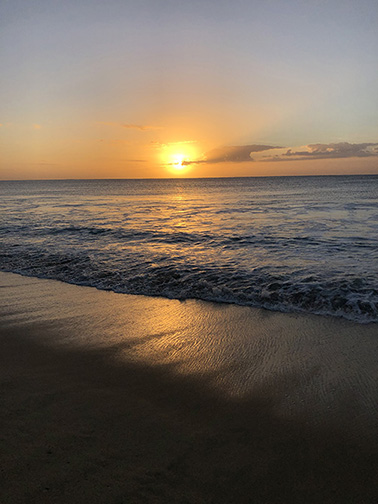 Sunrise at the beach with waves rolling in