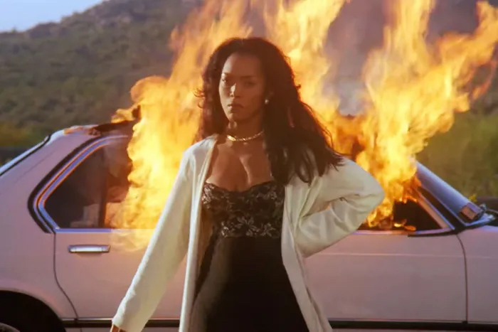 Angela Bassett walking away from a burning car in the 1995 film "Waiting to Exhale"