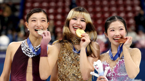 Alysa Liu, Kaori Sakamoto, and Ami Nakai bit their medals during the medal ceremony for Women's Single Skating at Milano Cortina 2026.